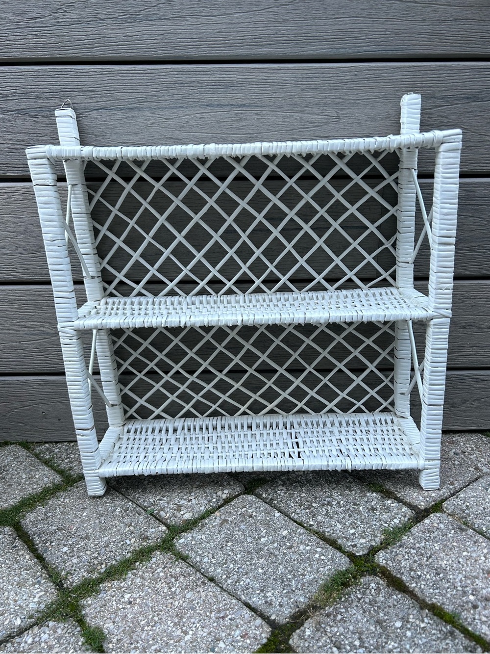 vintage 3-tier white wicker and rattan shelf with a decorative lattice backing